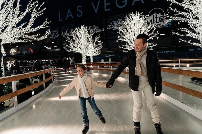 Men and child skating at Enchant Christmas