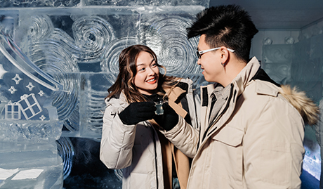 couple enjoying drinks at the ice wallsbar surrounded with ice