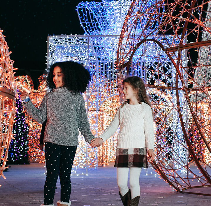 little girls exploring Enchant's light maze ornaments